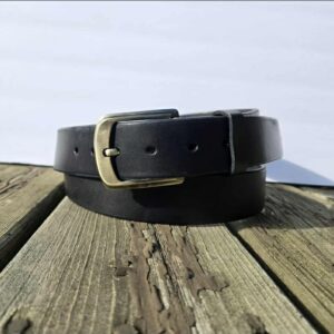 black_belt_folded_sitting_on_wooden_plank