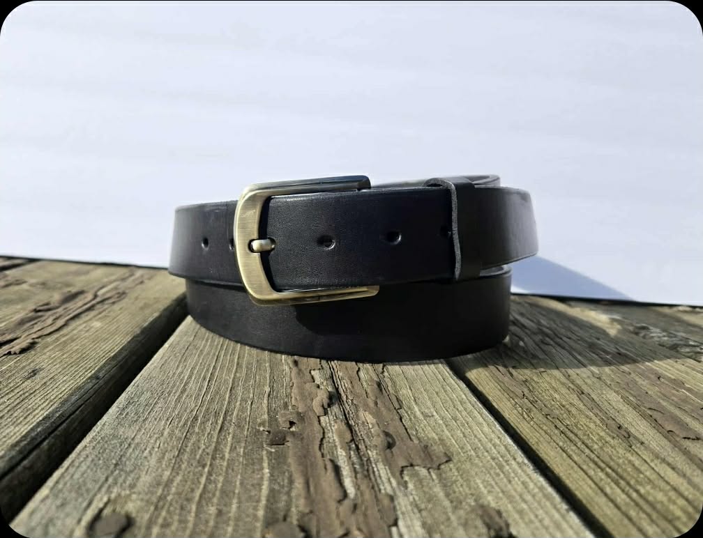 black_belt_folded_sitting_on_wooden_plank